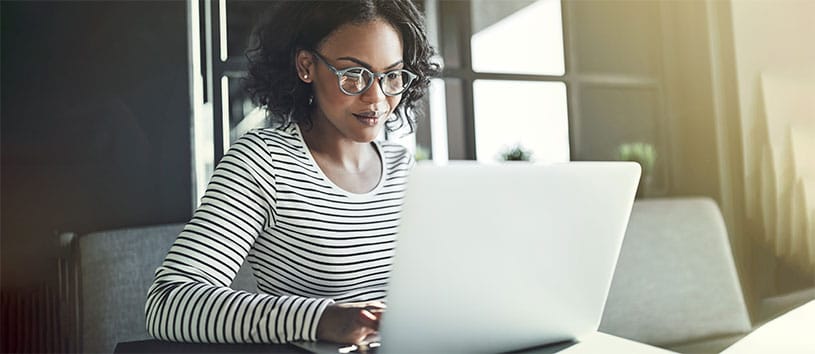 Digital and Social Media Marketing professional using her laptop for work.