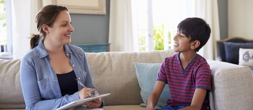 Human Services professional speaking to a child.